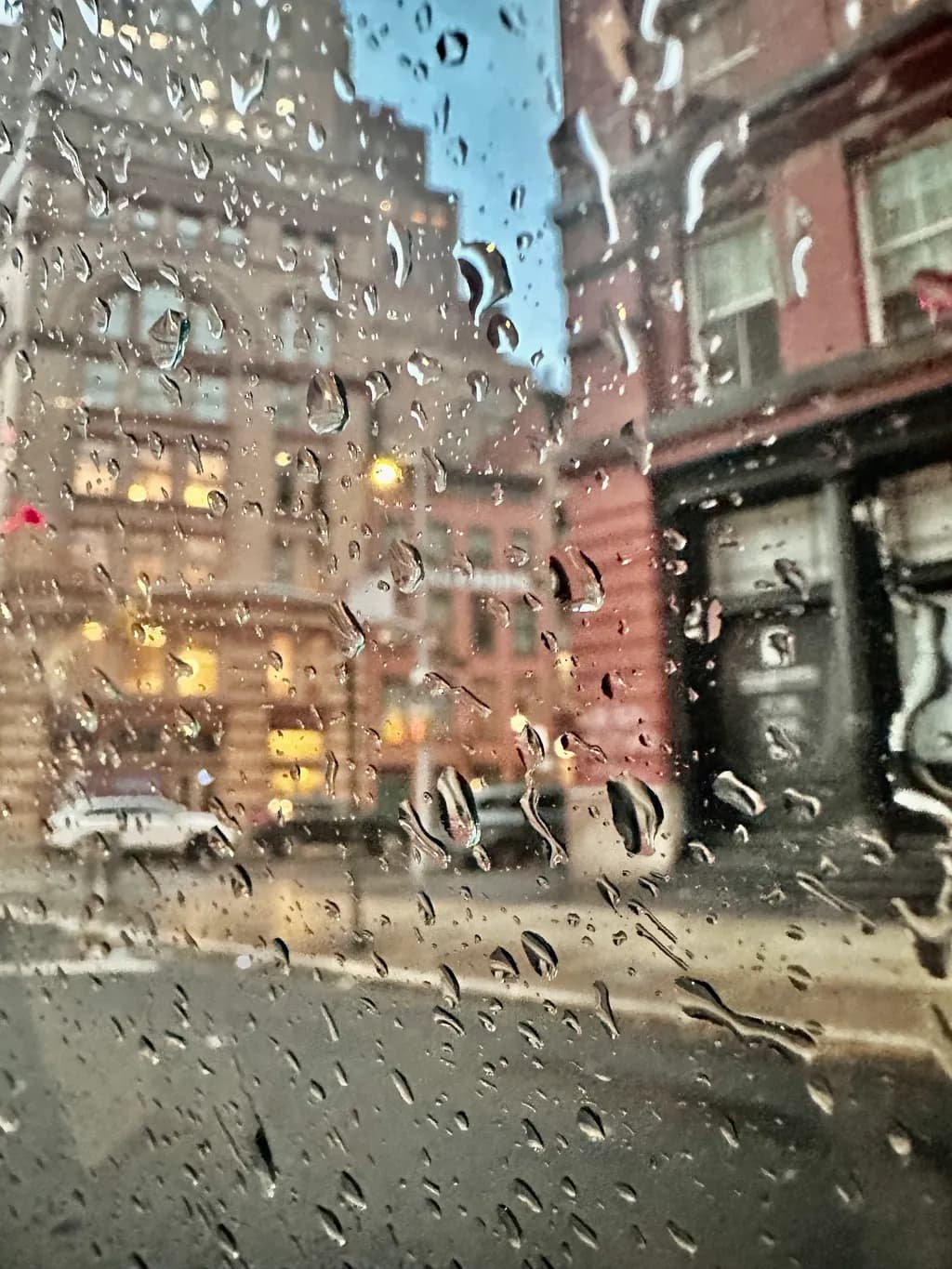 Urban Rain Symphony: A Glimpse Through the Raindrops