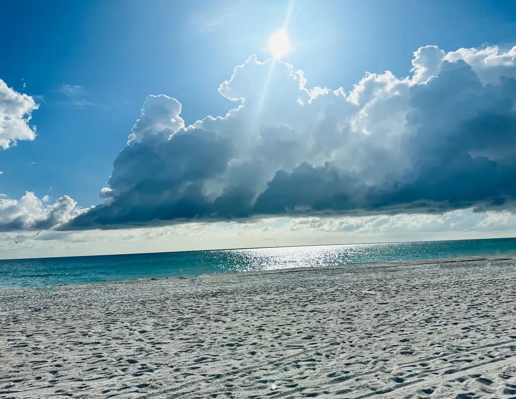 Serenity Beneath the Sunlit Clouds: A Tranquil Beachscape