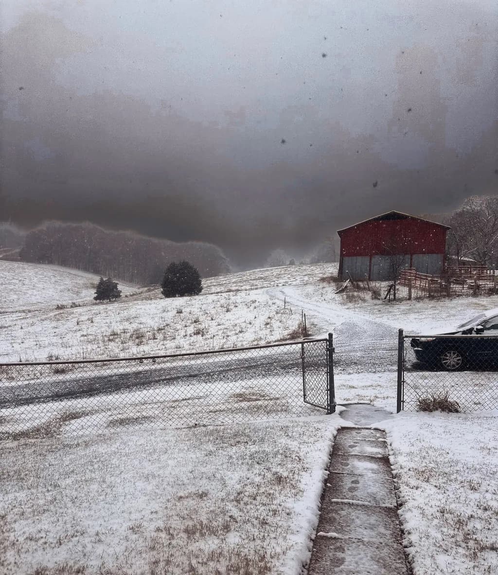 Whispers of Winter: A Snowy Landscape with a Rustic Barn in the Distance