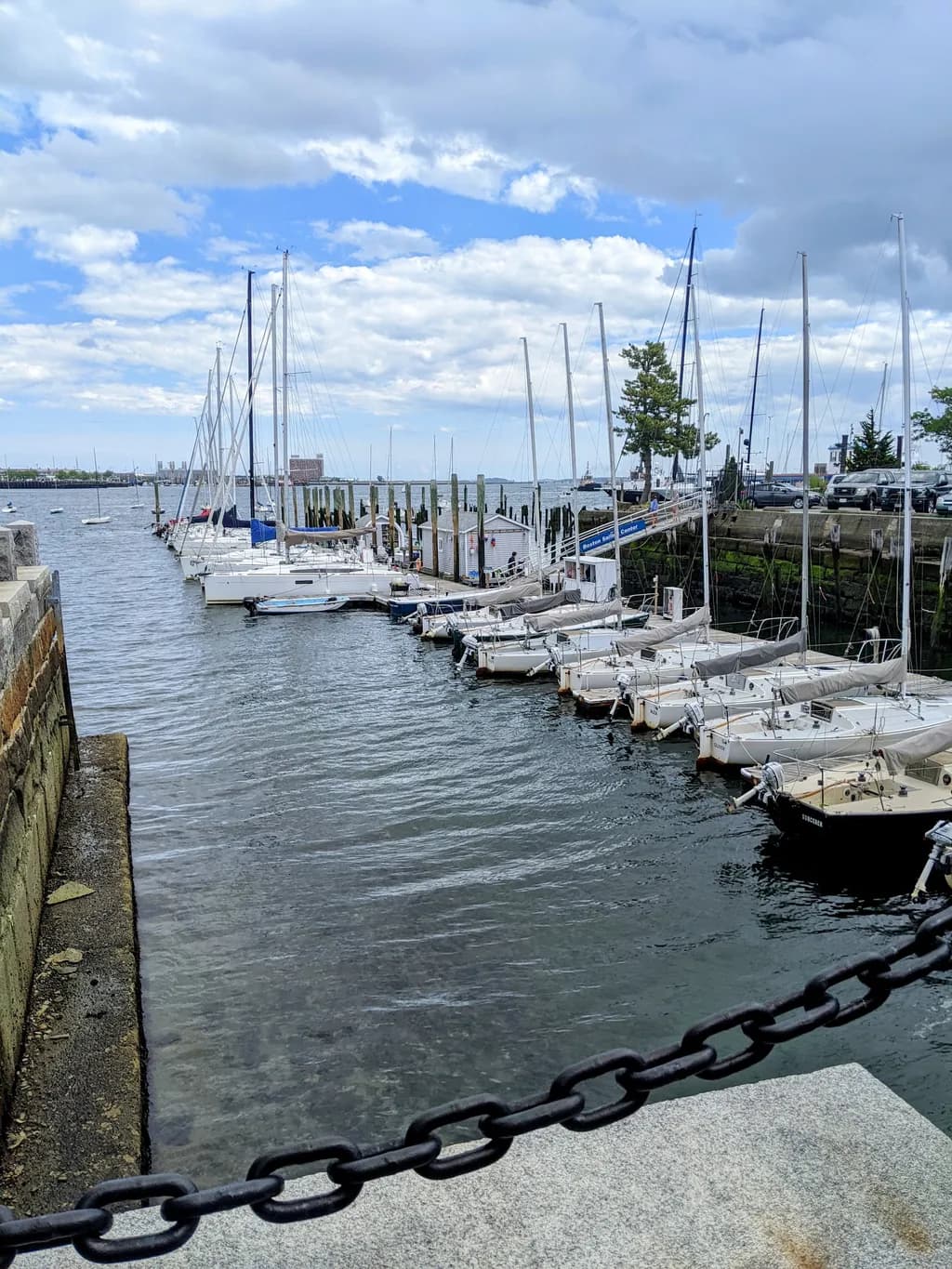 Serenity at the Marina: A Tranquil Harbor Scene with Boats and Clouds