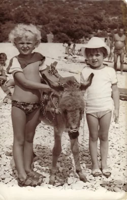 Whimsical Beach Memories: Children and Their Playful Donkey Companion