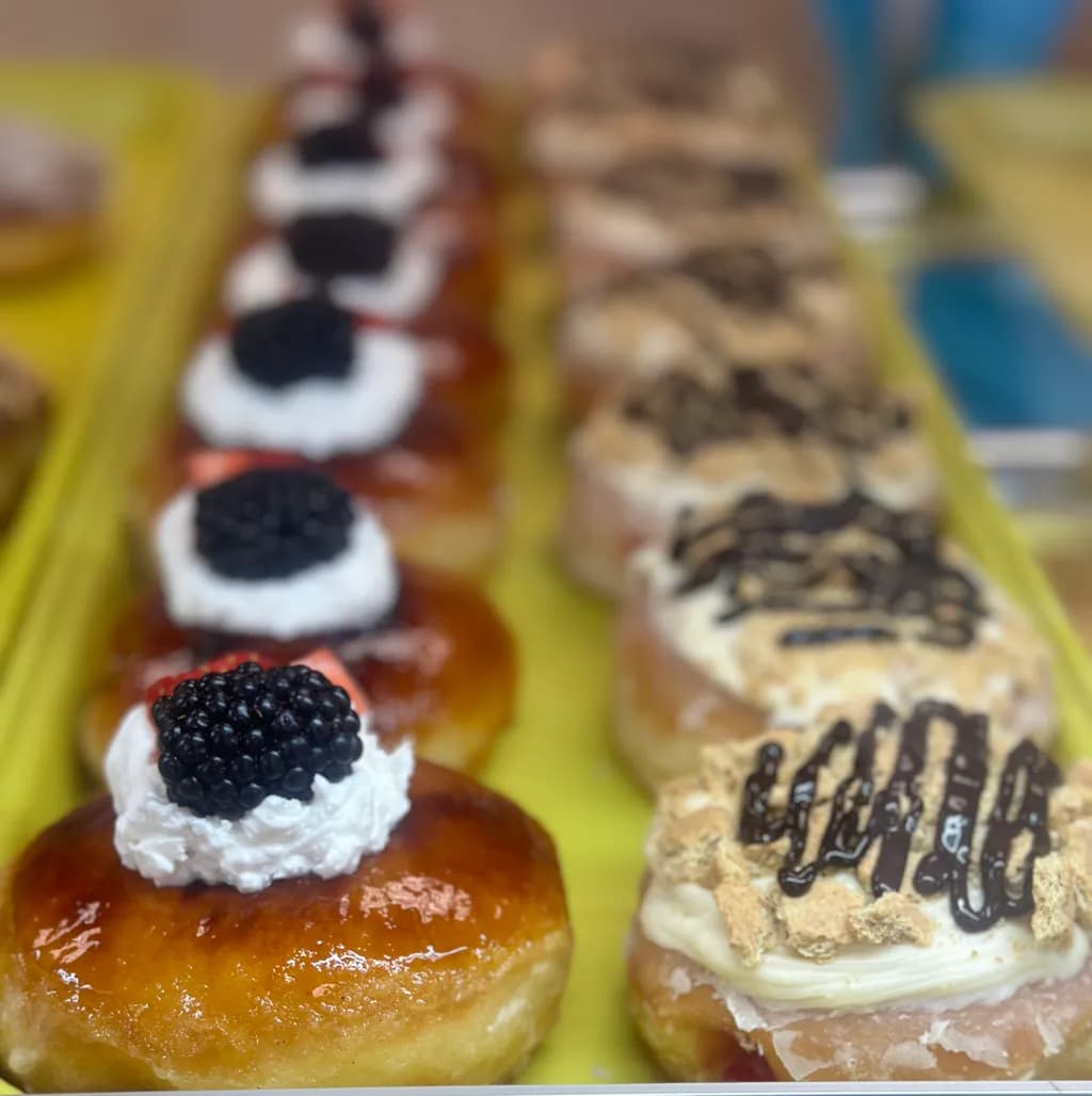 Decadent Delights: A Symphony of Gourmet Donuts with Whipped Cream and Chocolate Drizzle