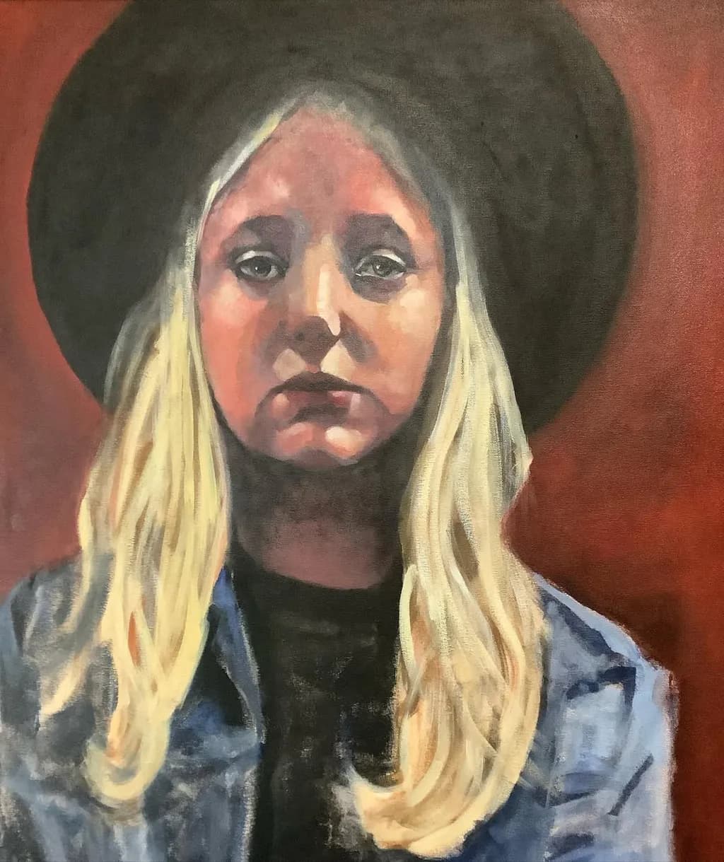Whispers of Expression: A Moody Portrait of a Blonde in a Hat