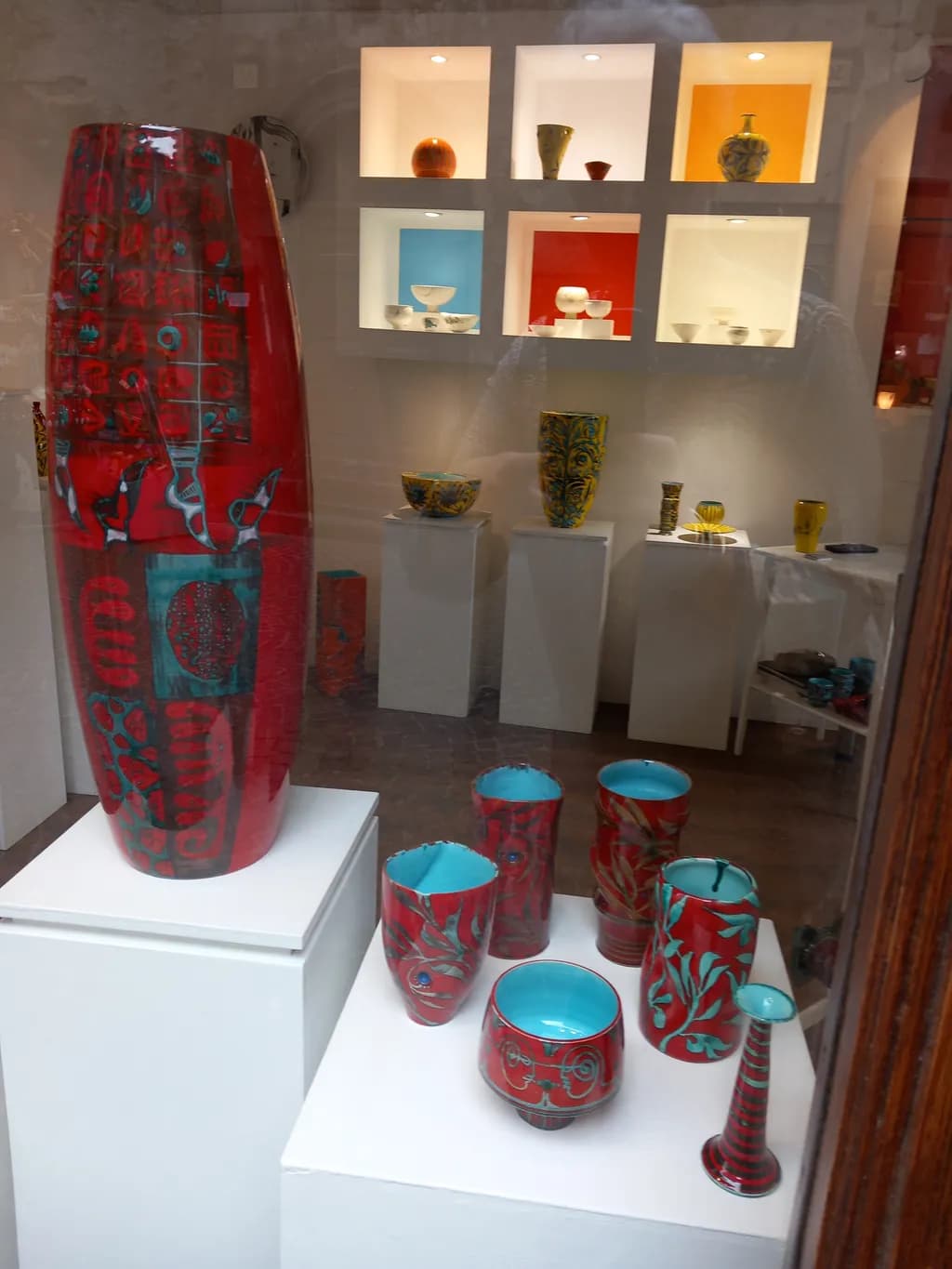 Vibrant Harmony: Handcrafted Ceramics in Bold Red and Turquoise Display