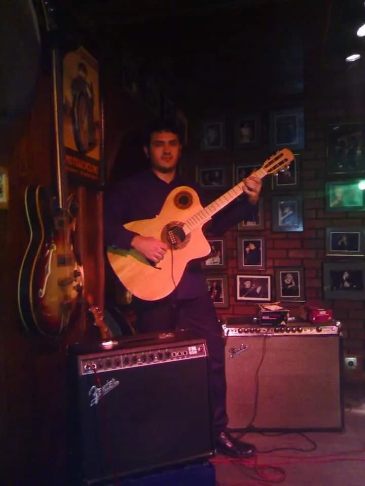Melodies in the Spotlight: A Guitarist's Intimate Performance in a Cozy Venue
