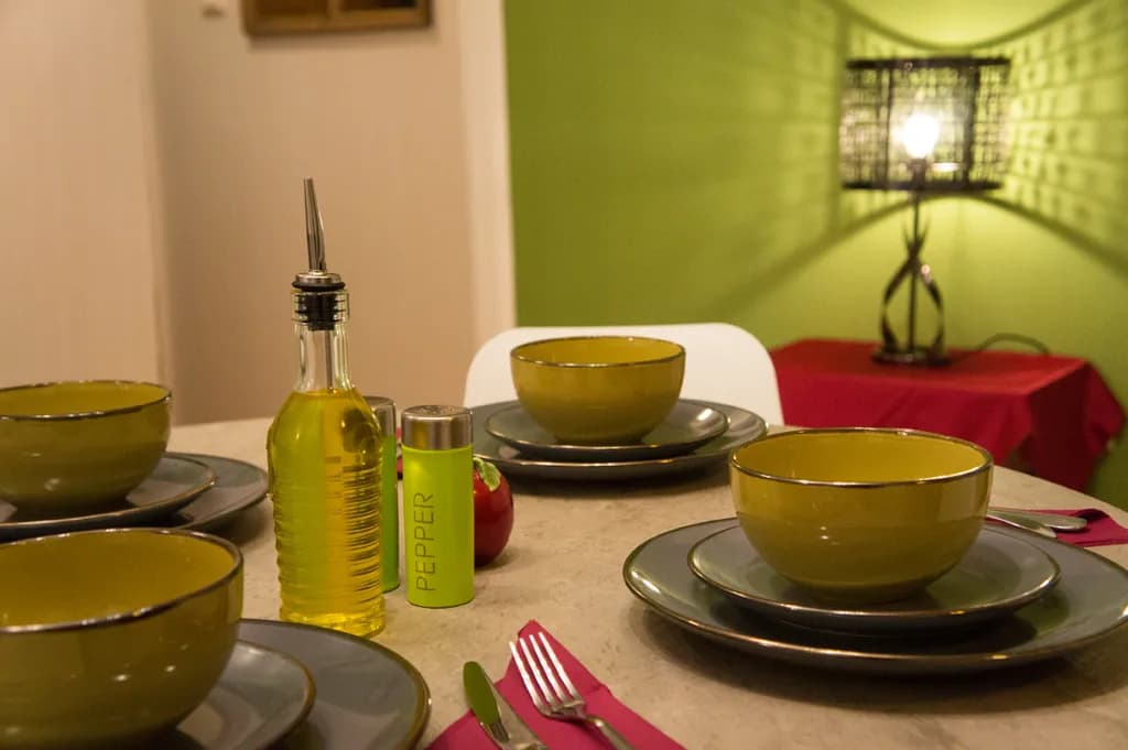 "Elegant Dining: A Cozy Table Setting with Olive Oil and Pepper"