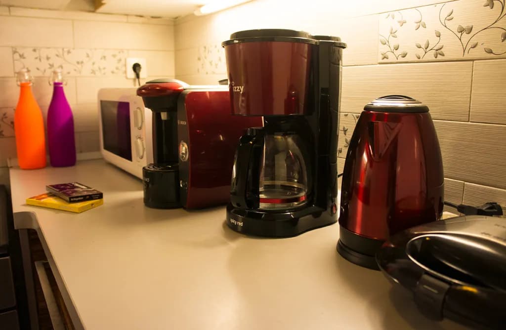 Morning Rituals: A Cozy Kitchen Still Life with Vibrant Appliances and Warm Light
