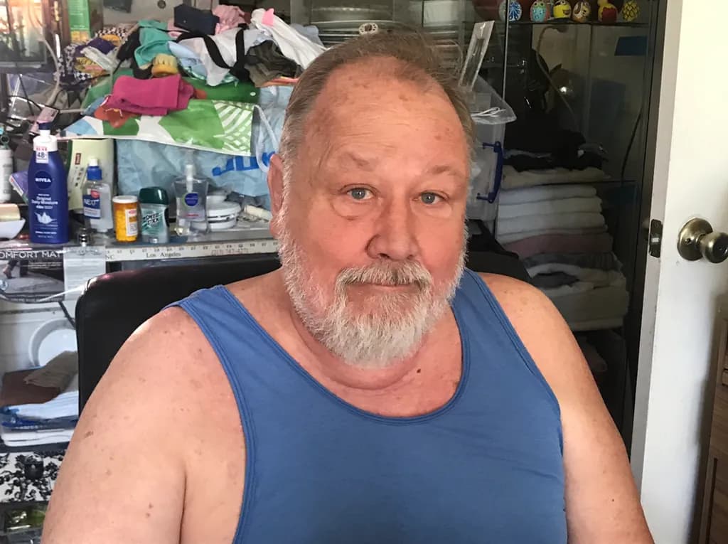 Relaxed Portrait of a Smiling Man in Casual Attire at Home