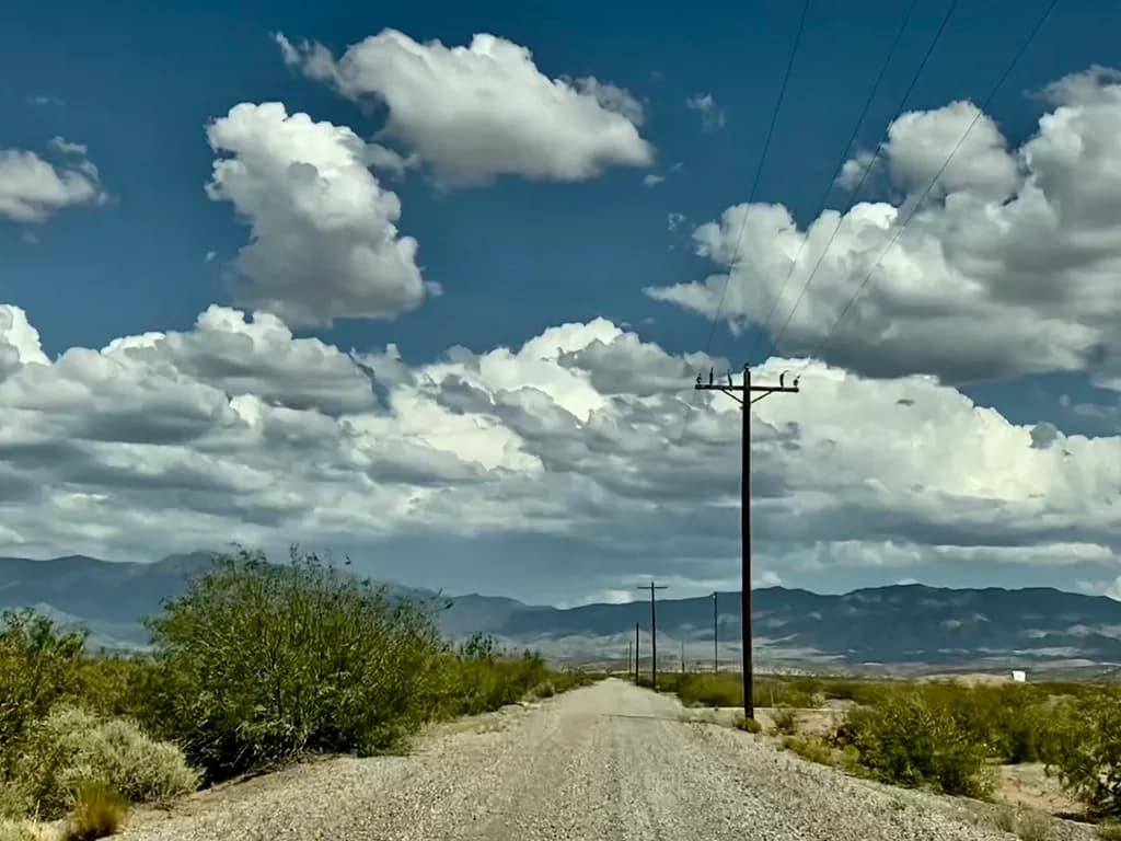 Desert Dreams: A Scenic Journey Through Cloud-Kissed Skies and Endless Roads