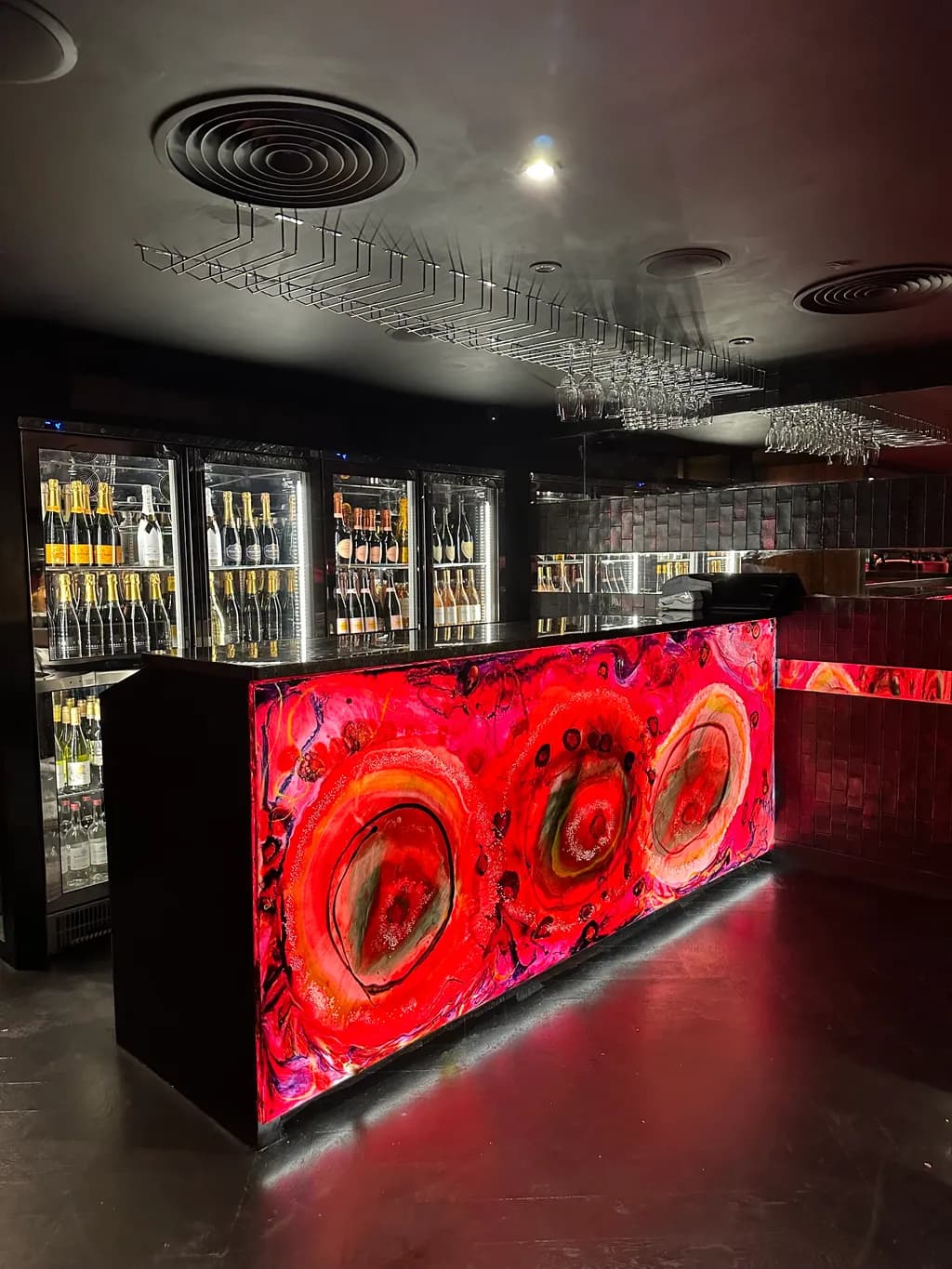 Vibrant Elegance: A Modern Bar Experience with Striking Lighting and Bold Design
