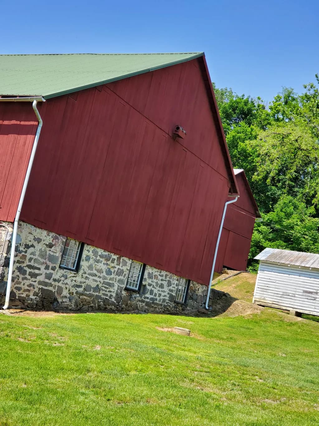 Whimsical Barn: A Playful Tilt of Rustic Charm in Nature's Embrace