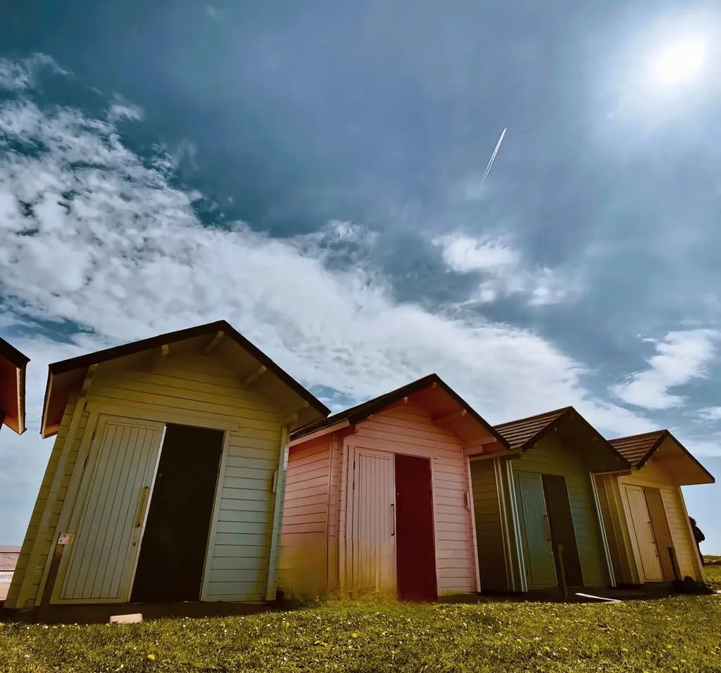 Vibrant Beach Huts Under a Summer Sky: A Colorful Escape