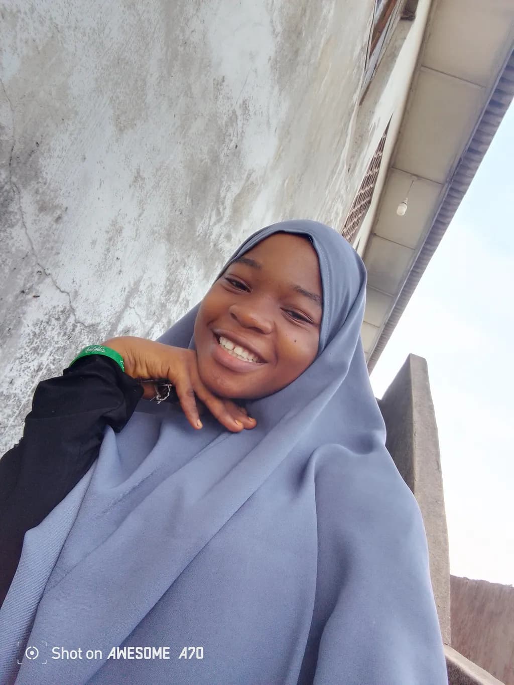 Joyful Embrace: A Portrait of Happiness in a Headscarf Outdoors