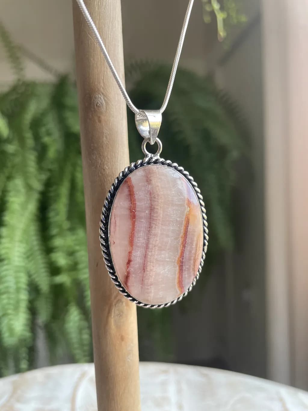 Whispers of Nature: Handcrafted Pink Stone Pendant in Silver Setting