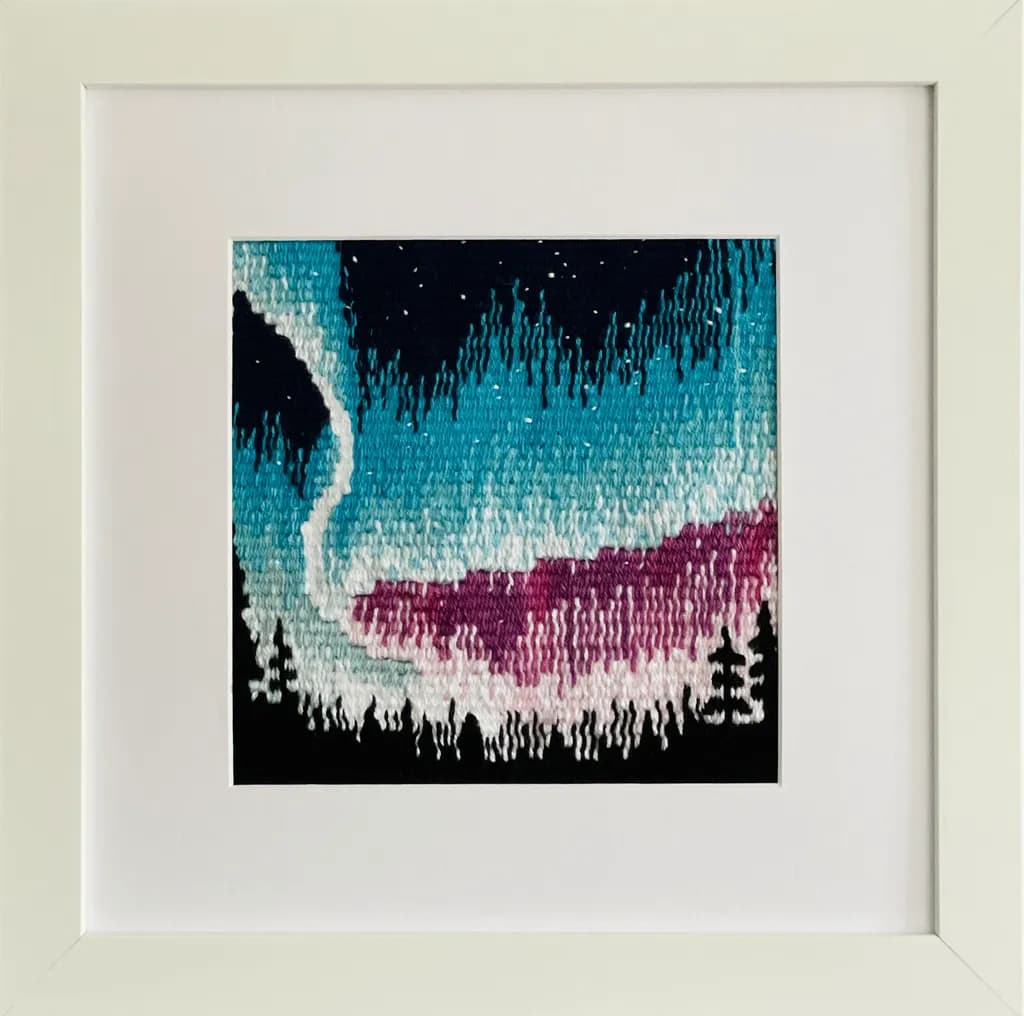 Aurora Dreams: A Colorful Embroidered Landscape Framed in Nature's Splendor