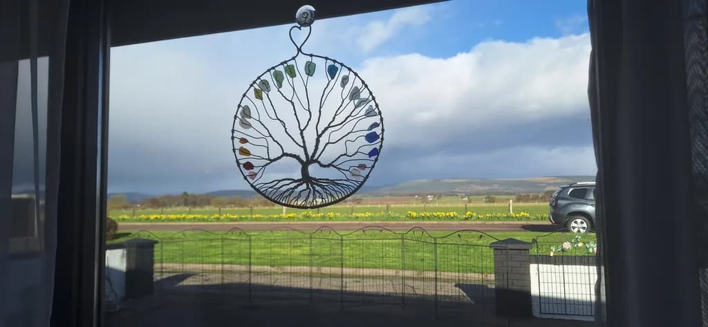 Whispers of Nature: A Colorful Tree of Life Framed by Scenic Landscapes