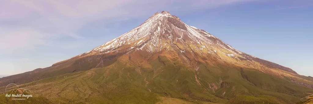 Majestic Eruption: The Timeless Beauty of a Snow-Capped Volcano at Dawn