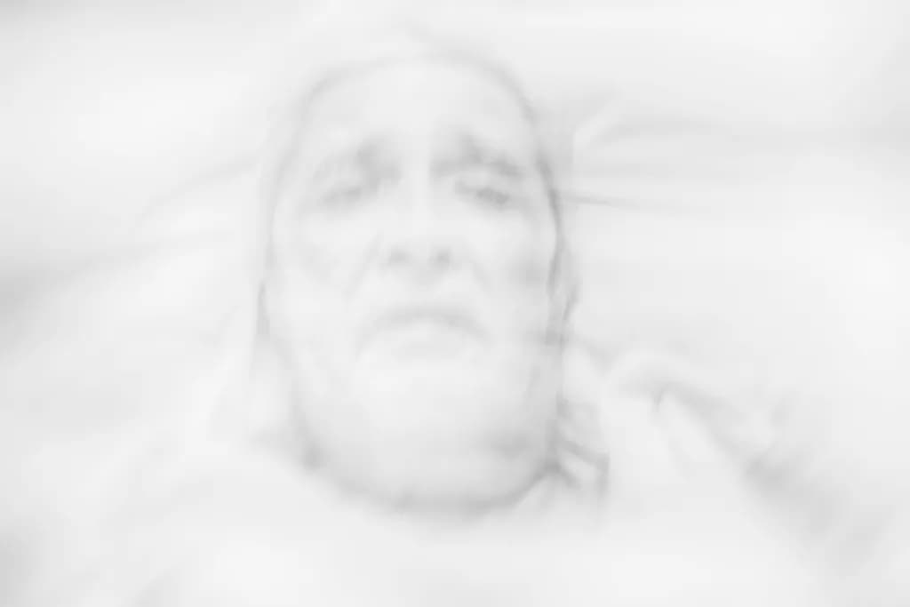 Ethereal Echoes of Grief: A Blurred Portrait of Transience and Emotion