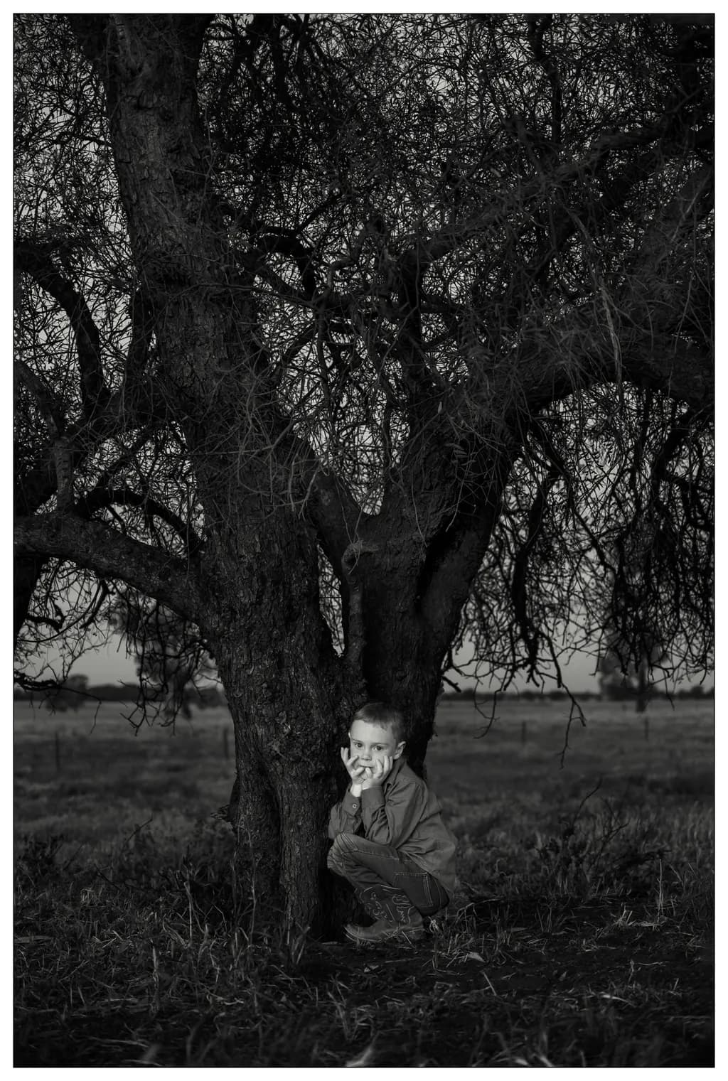 Whispers of Innocence: A Child's Embrace of Nature's Shadows