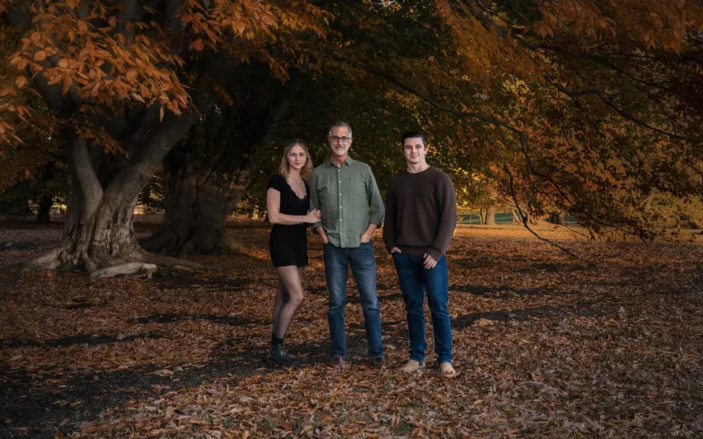 Autumn Embrace: A Family Portrait Amidst Golden Leaves
