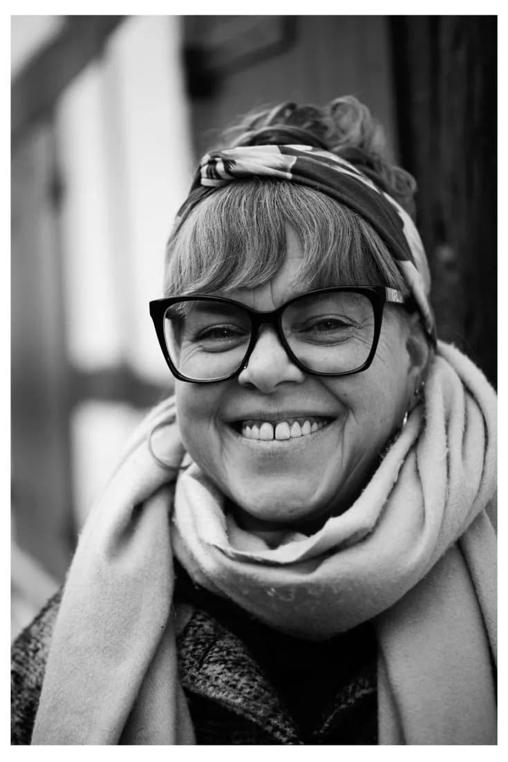 Joyful Elegance: A Black and White Portrait of Smiles and Scarfed Warmth