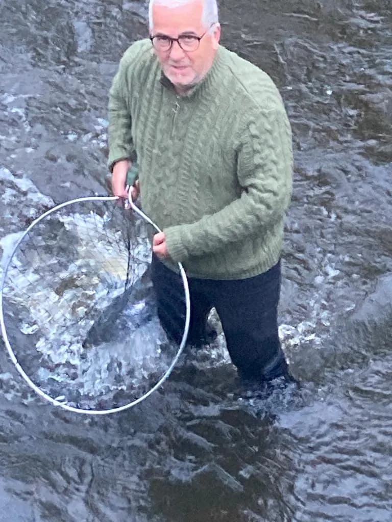 Gentleman in the Stream: A Serene Moment of Fishing Reflection