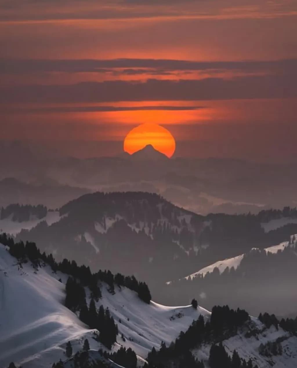 Whispers of Dusk: A Majestic Sunset Over Snow-Capped Peaks
