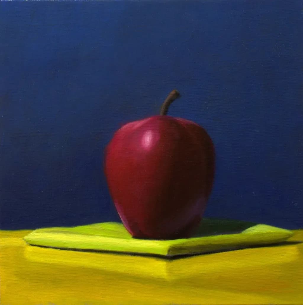 Vibrant Still Life: A Bold Red Apple on a Bright Yellow Canvas