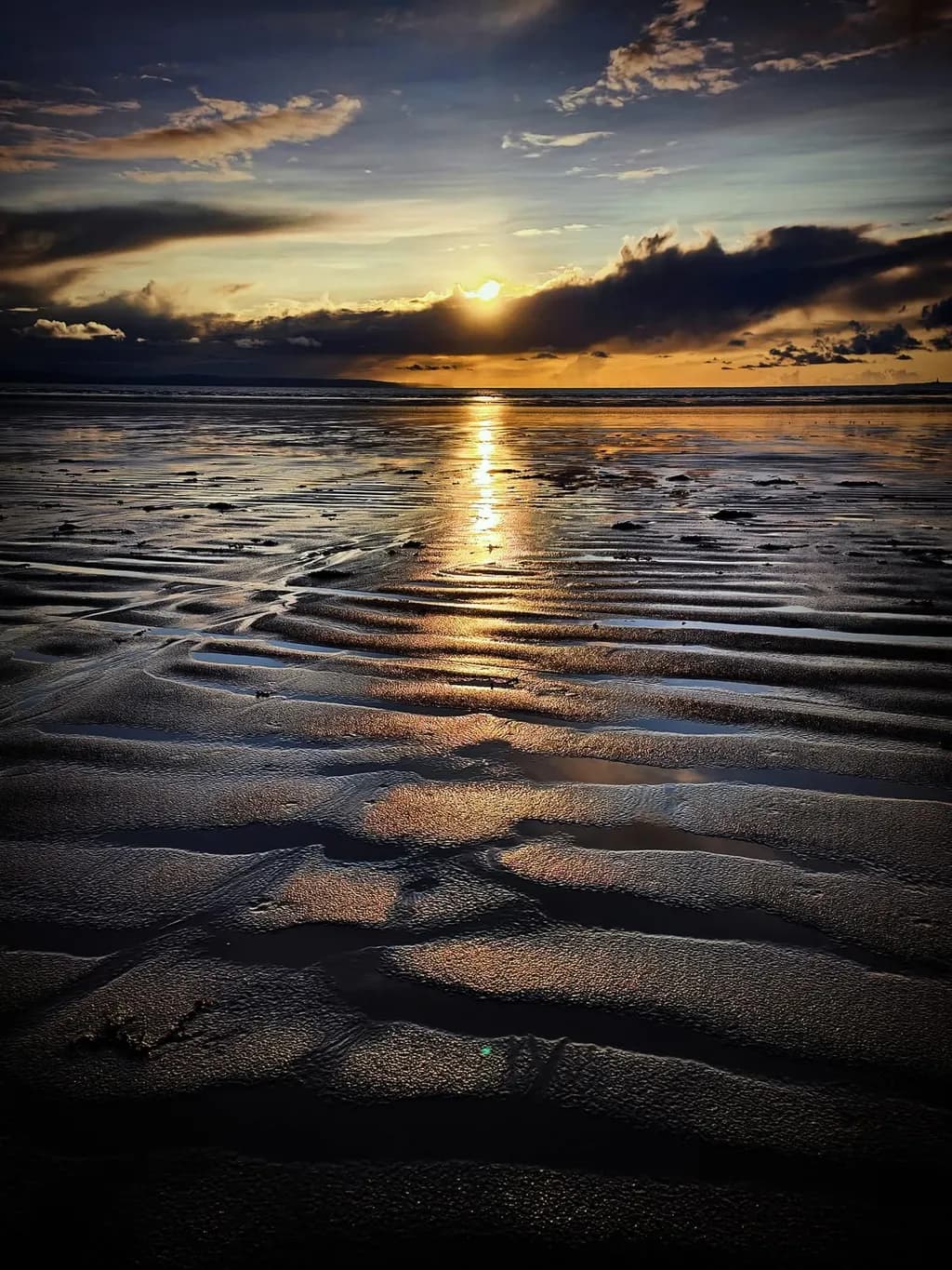 Serenity at Sunset: A Tranquil Beach Reflection in Golden Hues