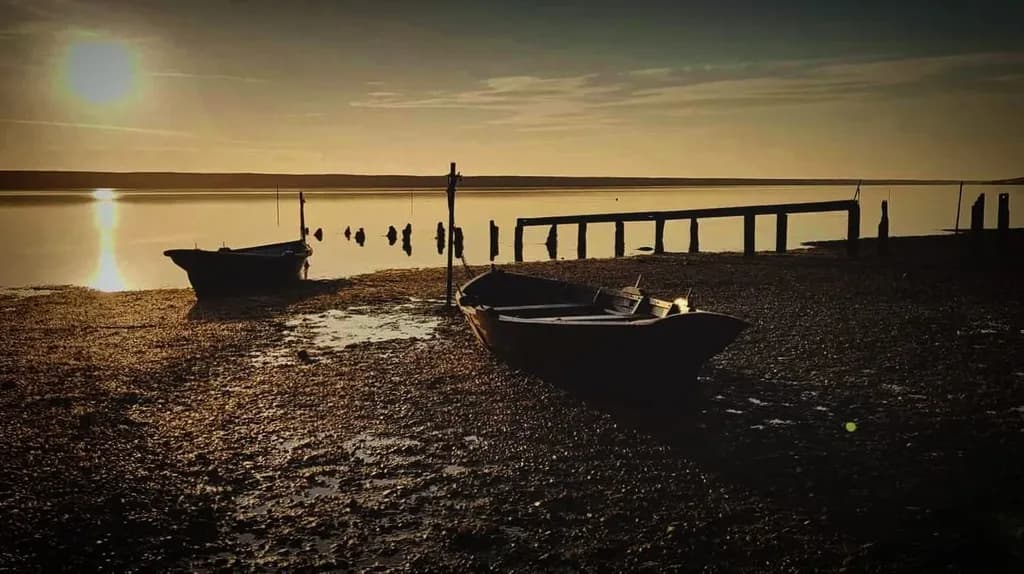 Whispers of the Tide: A Serene Sunset Over Still Waters