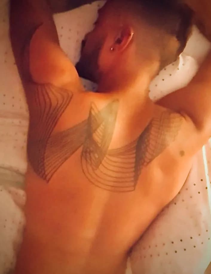 Whispers of Ink: A Serene Tattoo Embracing the Body's Canvas