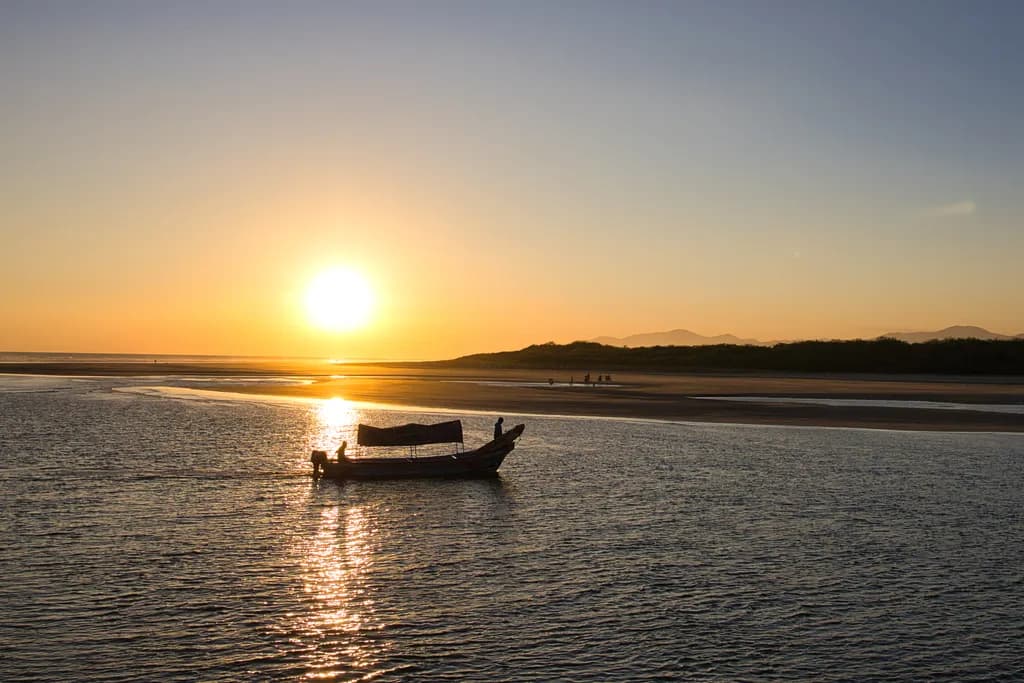 Serenity at Sunset: A Tranquil Reflection on Water with a Boat in the Landscape
