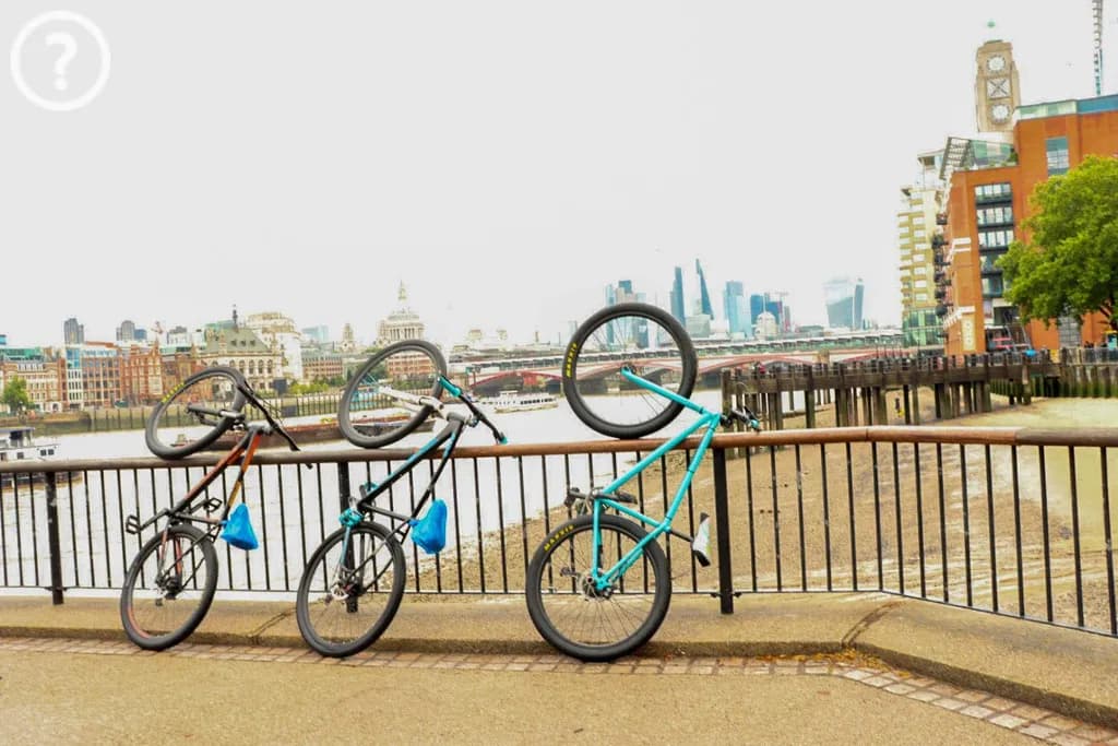 Urban Serenity: Bicycles Resting by the River Thames in a Cityscape Embrace