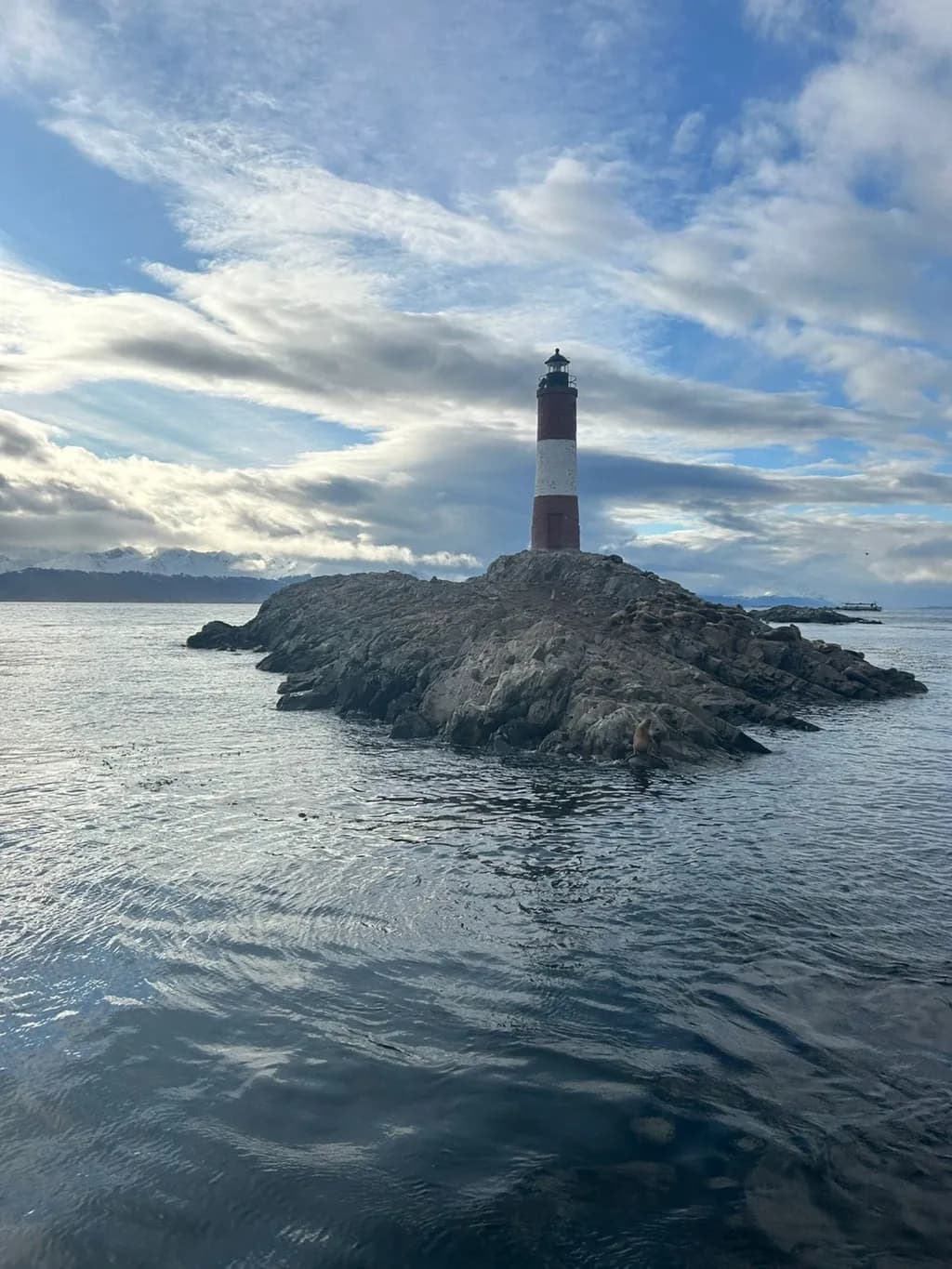 Lighthouse Serenity: A Coastal Reflection Beneath the Clouds