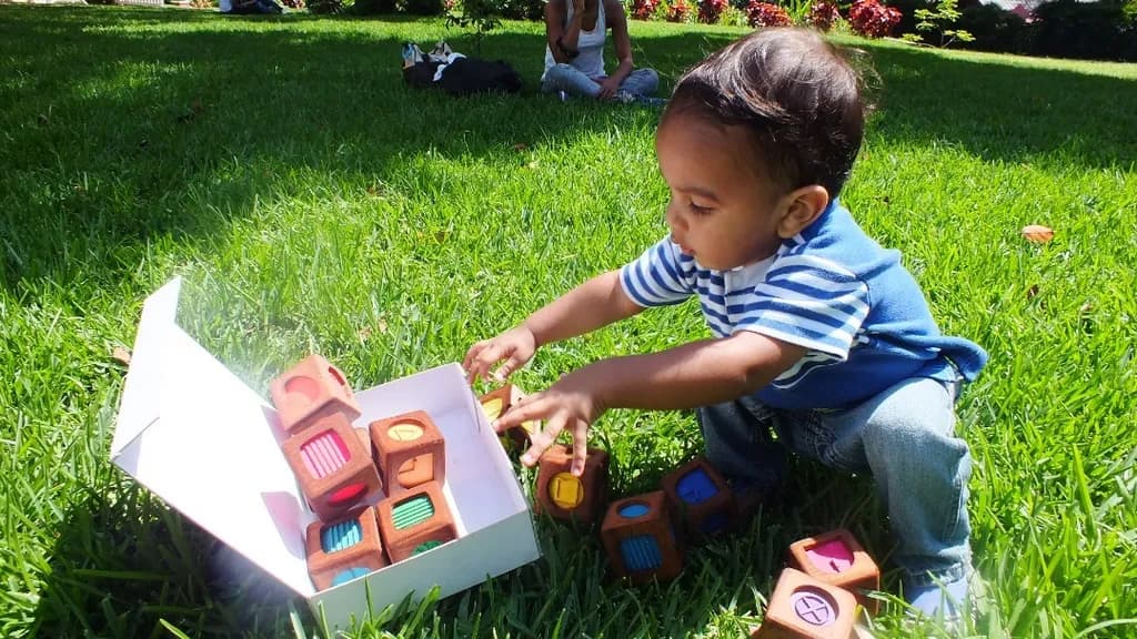 Joyful Discovery: A Child's Playtime in Nature with Colorful Building Blocks