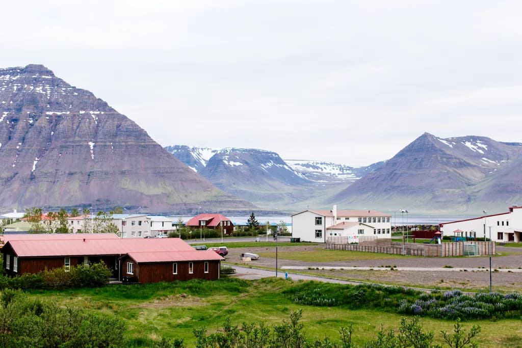 Serenity in the Shadows: A Tranquil Mountain Landscape with Charming Buildings and Lush Nature