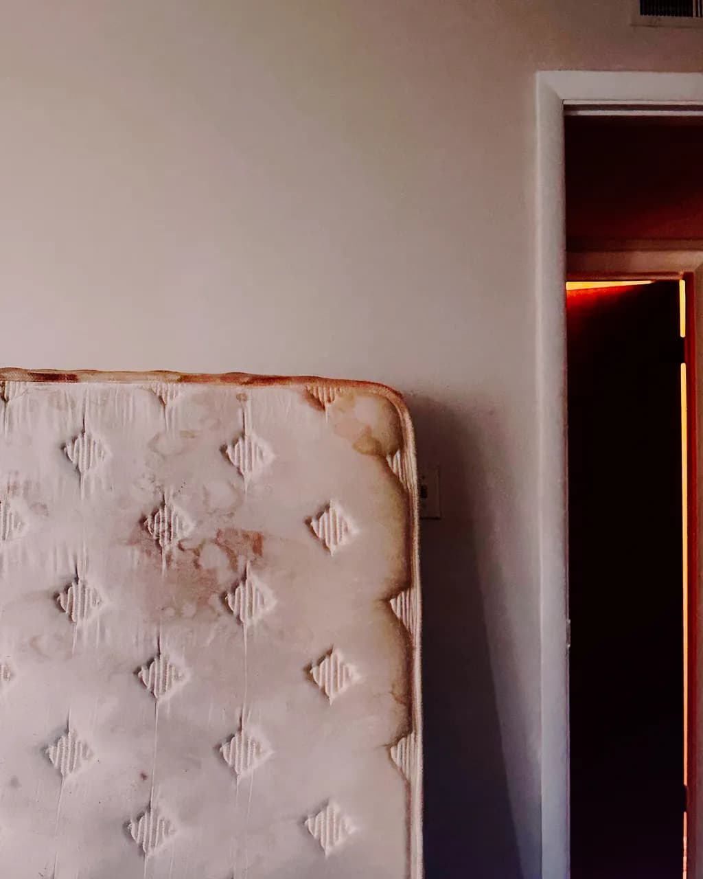 Whispers of Abandonment: A Mattress in the Doorway of Forgotten Dreams