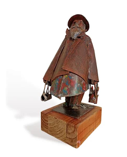 Rustic Wanderer: A Captivating Metal Sculpture of a Weathered Traveler
