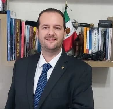 Confident Professional Portrait with Bookshelf and Flag Background