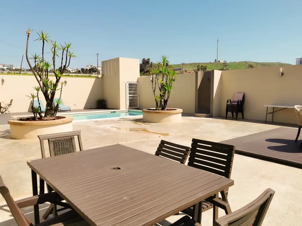 Serene Oasis: A Tranquil Poolside Retreat with Lush Greenery and Modern Comforts