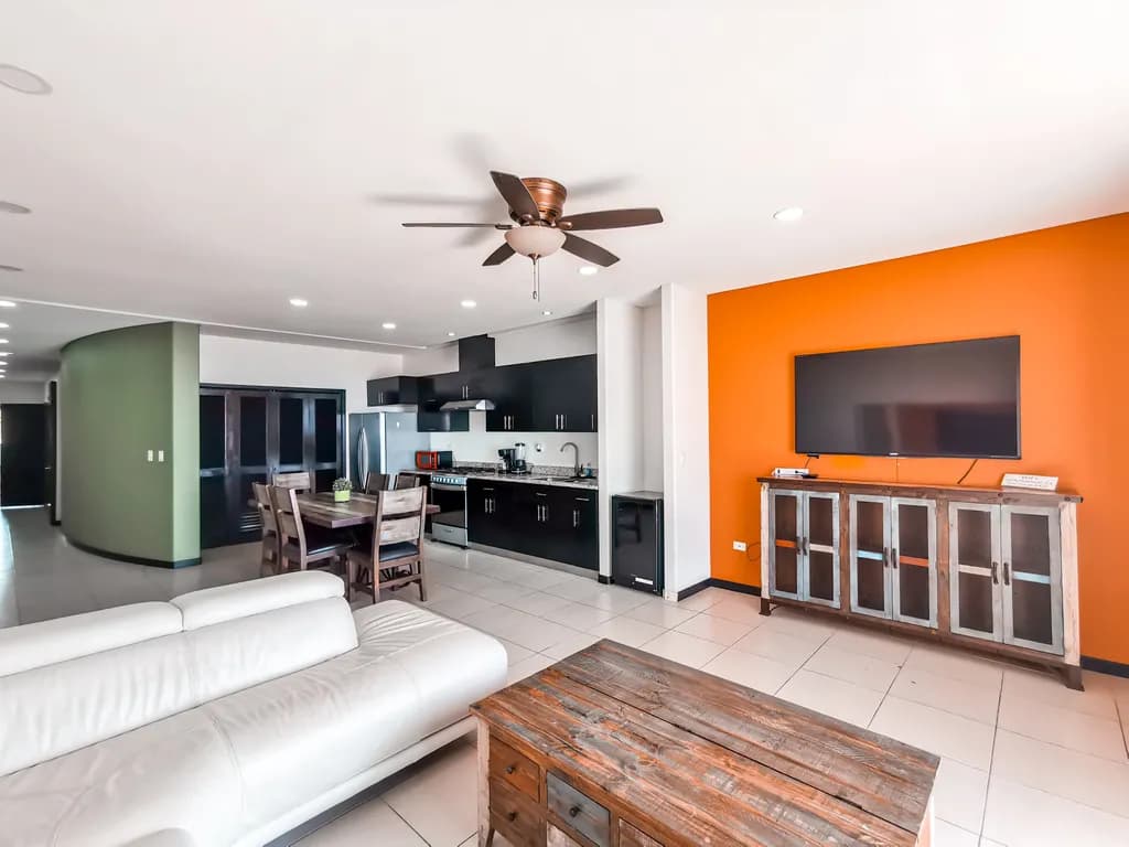 Modern Serenity: A Chic Open-Concept Living Space with Vibrant Accents and Timeless Elegance