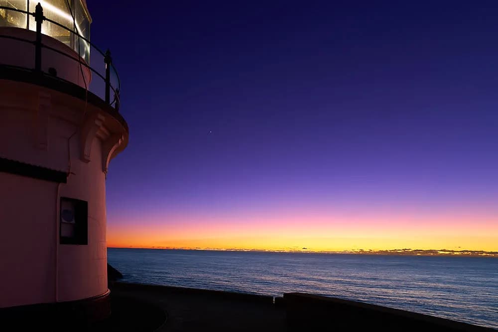 Whispers of Twilight: A Lighthouse at Dusk Over the Tranquil Sea
