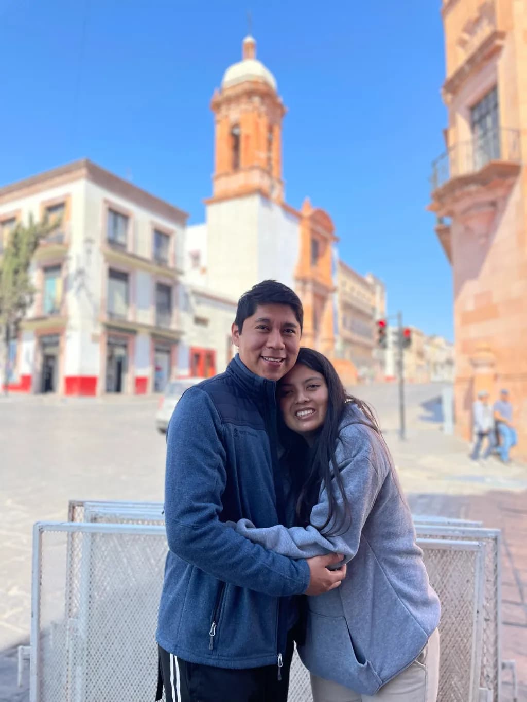 Embracing Moments: A Heartfelt Connection in a Vibrant Cityscape