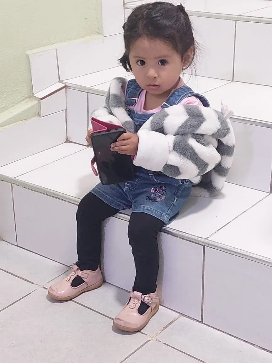 Charming Innocence: A Little Girl in Cozy Layers on the Steps of Imagination