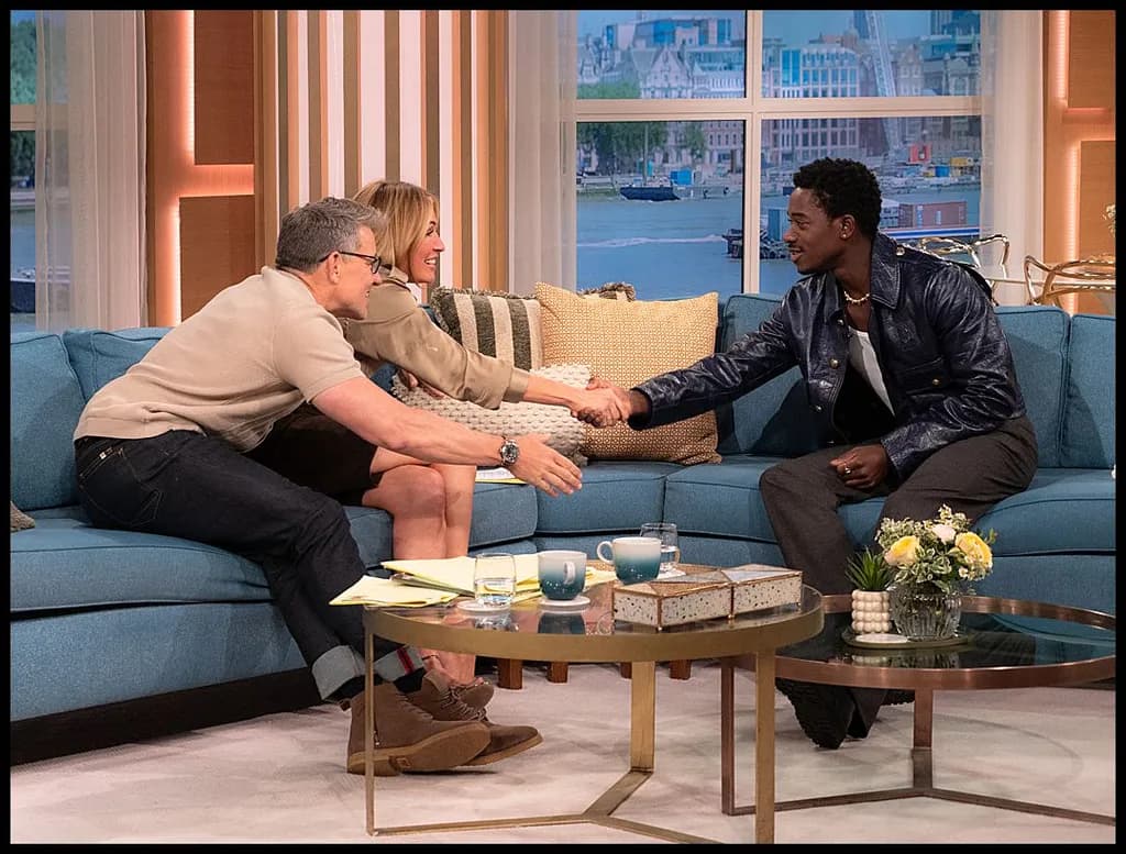 "Moments of Connection: A Warm Embrace on the Talk Show Couch"
