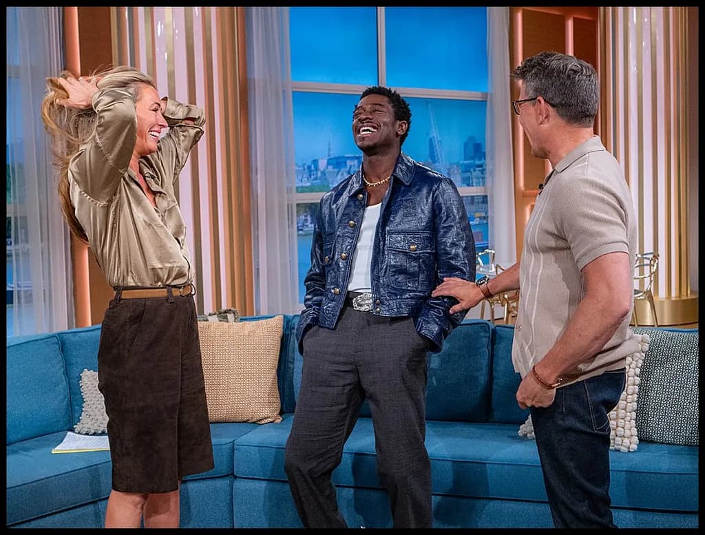 Joyful Connections: A Candid Moment of Laughter and Style on Set