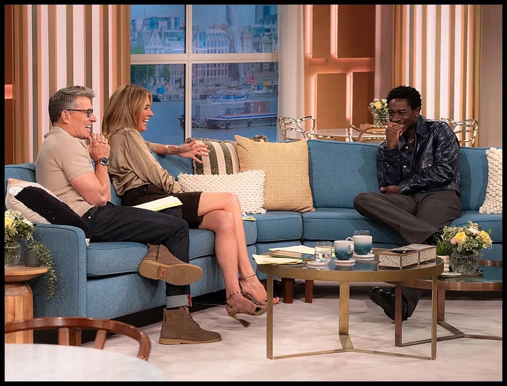 Laughter and Connection: A Joyful Moment on the Talk Show Sofa