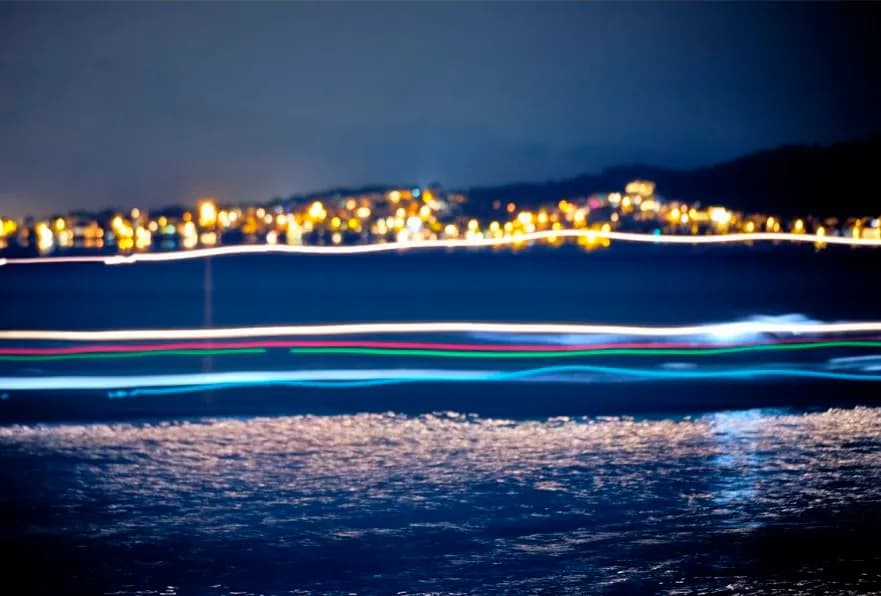 Whispers of Light: A Serene Night by the Water's Edge