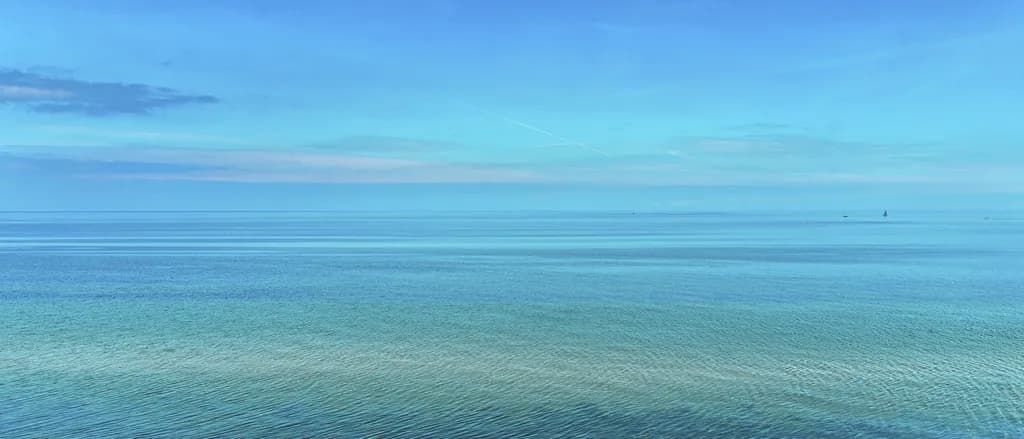 Whispers of Tranquility: A Serene Seascape Embracing Calm Waters and Endless Skies
