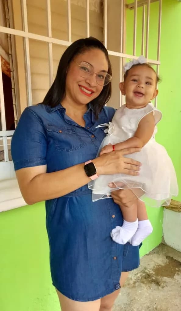 Joyful Moments: A Mother’s Embrace with Her Smiling Child in a Vibrant Setting
